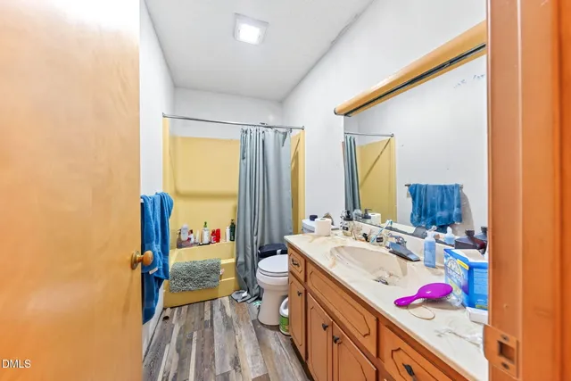 a en suite bathroom with a sink and a large mirror