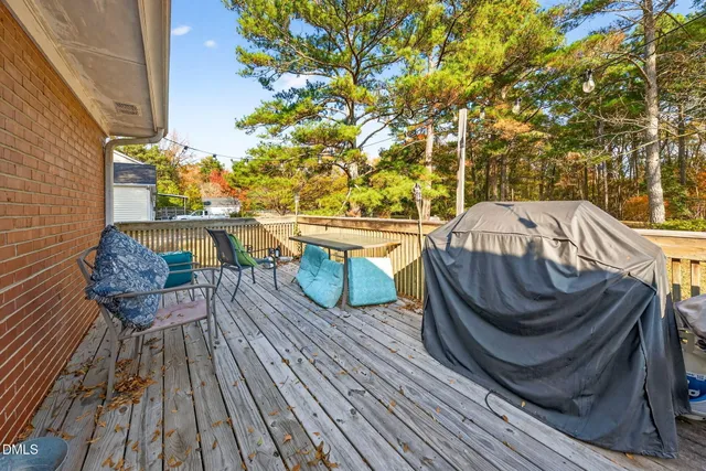 a view of balcony with wooden floor and outdoor seating