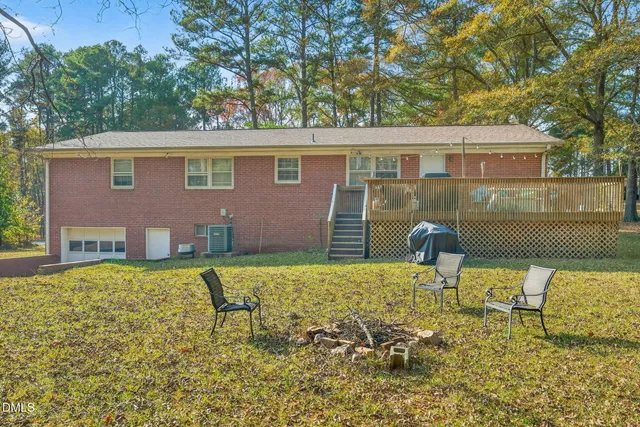 a backyard of a house with table and chairs