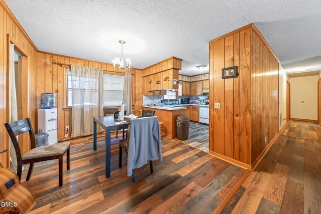 a very nice looking living room with a large window and wooden floor