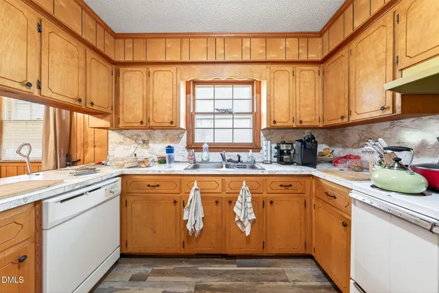 a kitchen with stainless steel appliances granite countertop a sink a stove and cabinets