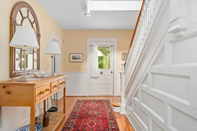 a view of a hallway with wooden floor and windows
