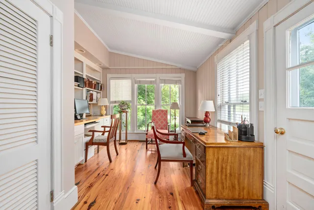a living room with furniture a window and a table
