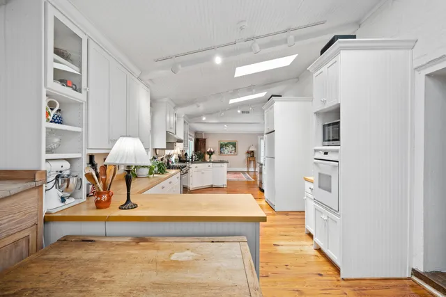 a bathroom with a sink a toilet and a window