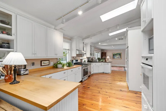 a bathroom with a toilet a sink and a window
