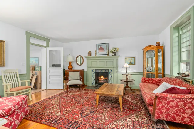 a front view of a house with a garden and trees