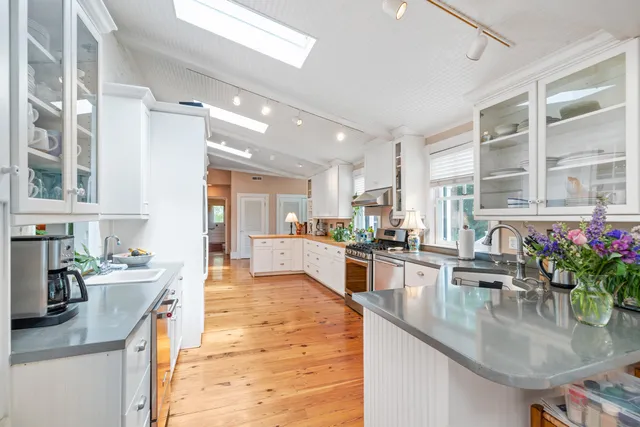 a picture of a bench in front of a white house