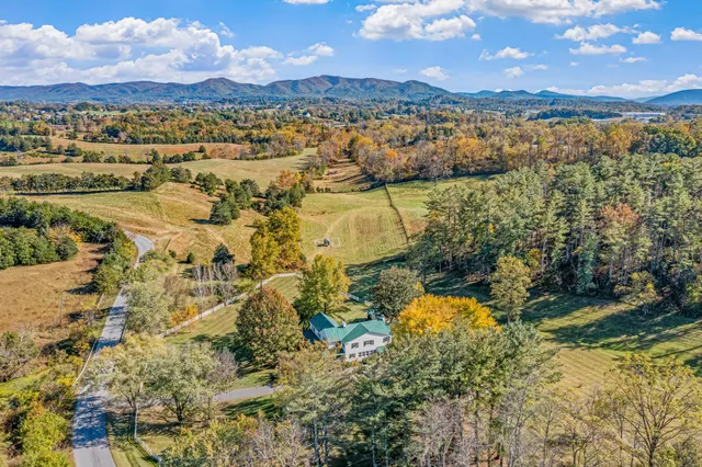 a living room with a baby crib furniture and a window