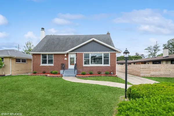 a front view of a house with a yard and porch