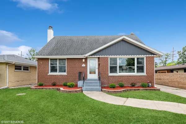 a front view of house with yard and green space