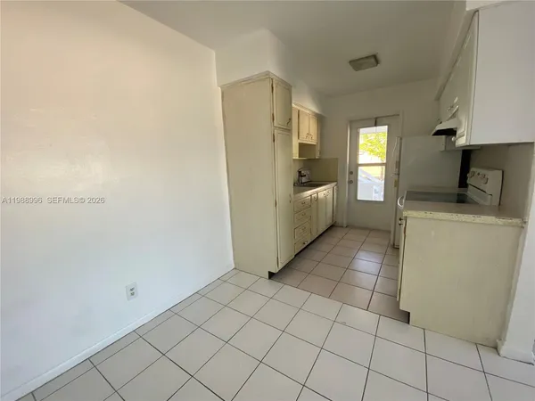 a kitchen with a sink and a refrigerator