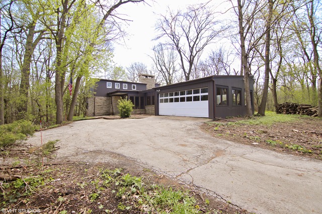 1655 Sunset Ridge Road Northbrook, IL 60062 - Photo 1 of 12 a view of a house with a yard covered in snow