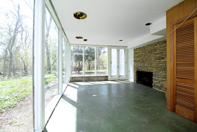 1655 Sunset Ridge Road Northbrook, IL 60062 - Photo 6 of 12 a view of an empty room with a fireplace and a window