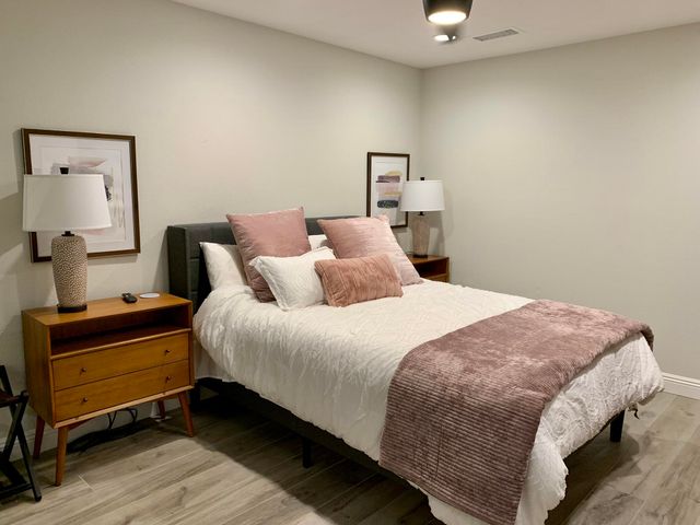 a bedroom with a bed and a chandelier