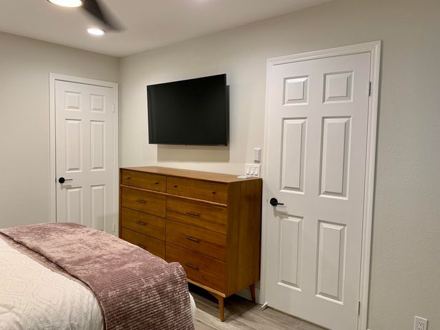 a bedroom with a bed and a flat screen tv