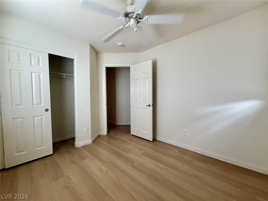 11183 Ranch Valley Street Las Vegas, NV 89179 - Photo 12 of 19 Laminate flooring and a ceiling fan create a comfortable and modern space.
