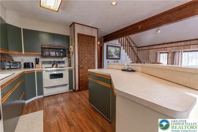 a kitchen with stainless steel appliances a stove a sink and a refrigerator