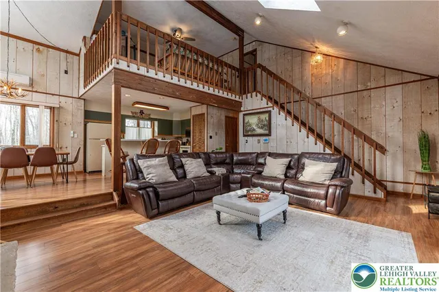 a living room with furniture or stairs and a wooden floor