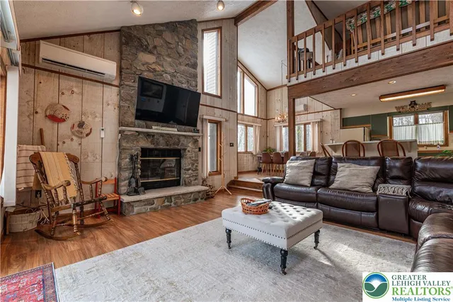 a living room with furniture fireplace and flat screen tv