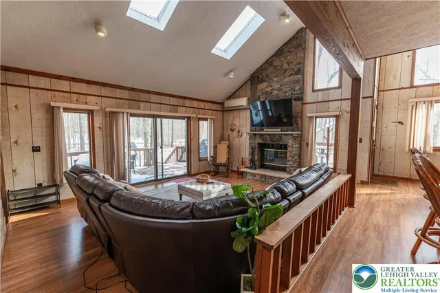 a living room with furniture fireplace and flat screen tv