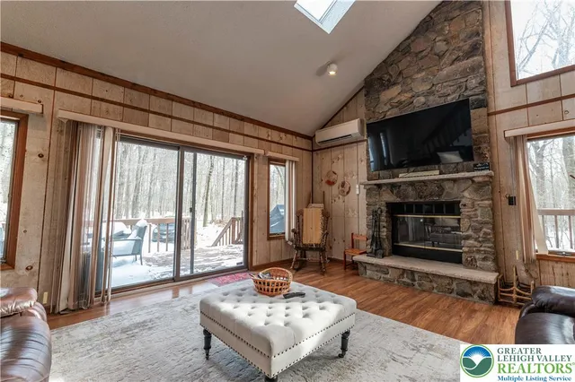 a living room with fireplace furniture and a flat screen tv