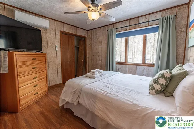 a bedroom with a bed and a flat screen tv