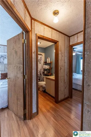 a view of a hallway with wooden floor fireplace and living room