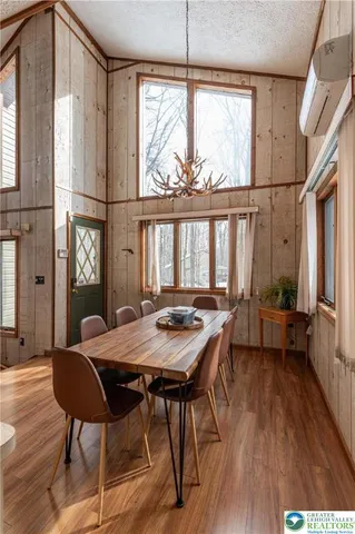 a view of a dining room with furniture window and wooden floor