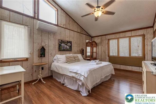 a bedroom with a bed mirror and a window