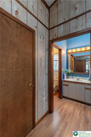 a bathroom with a toilet a sink and a mirror