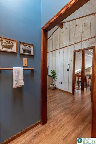 a view of a room with wooden floor