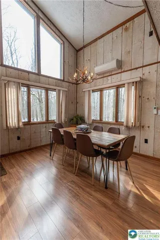 a view of a dining room with furniture window and wooden floor