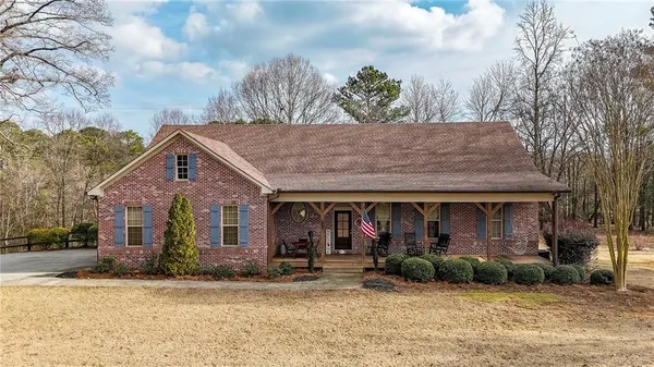 a front view of a house with garden and plants