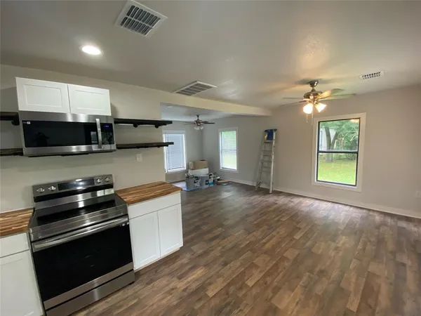 a kitchen with stainless steel appliances a stove a sink and a microwave
