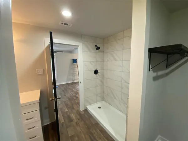 a bathroom with a shower and a tub