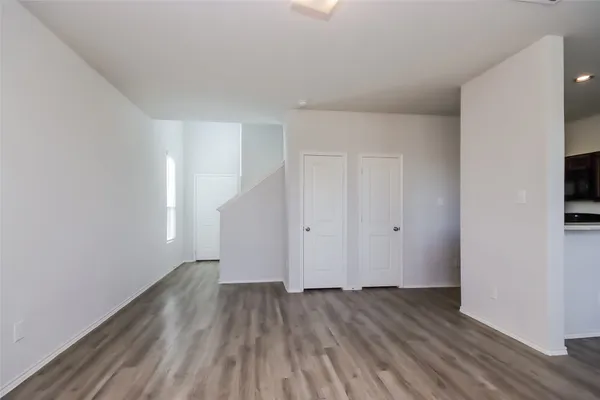a view of a room with wooden floor and white doors