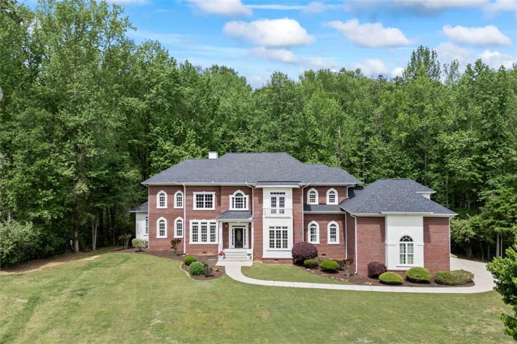 a front view of a house with a garden