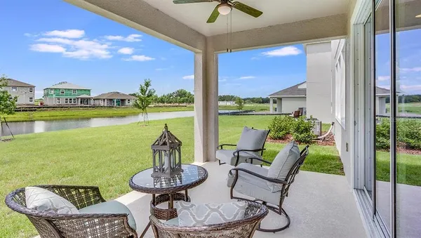 a view of a patio with lawn chairs