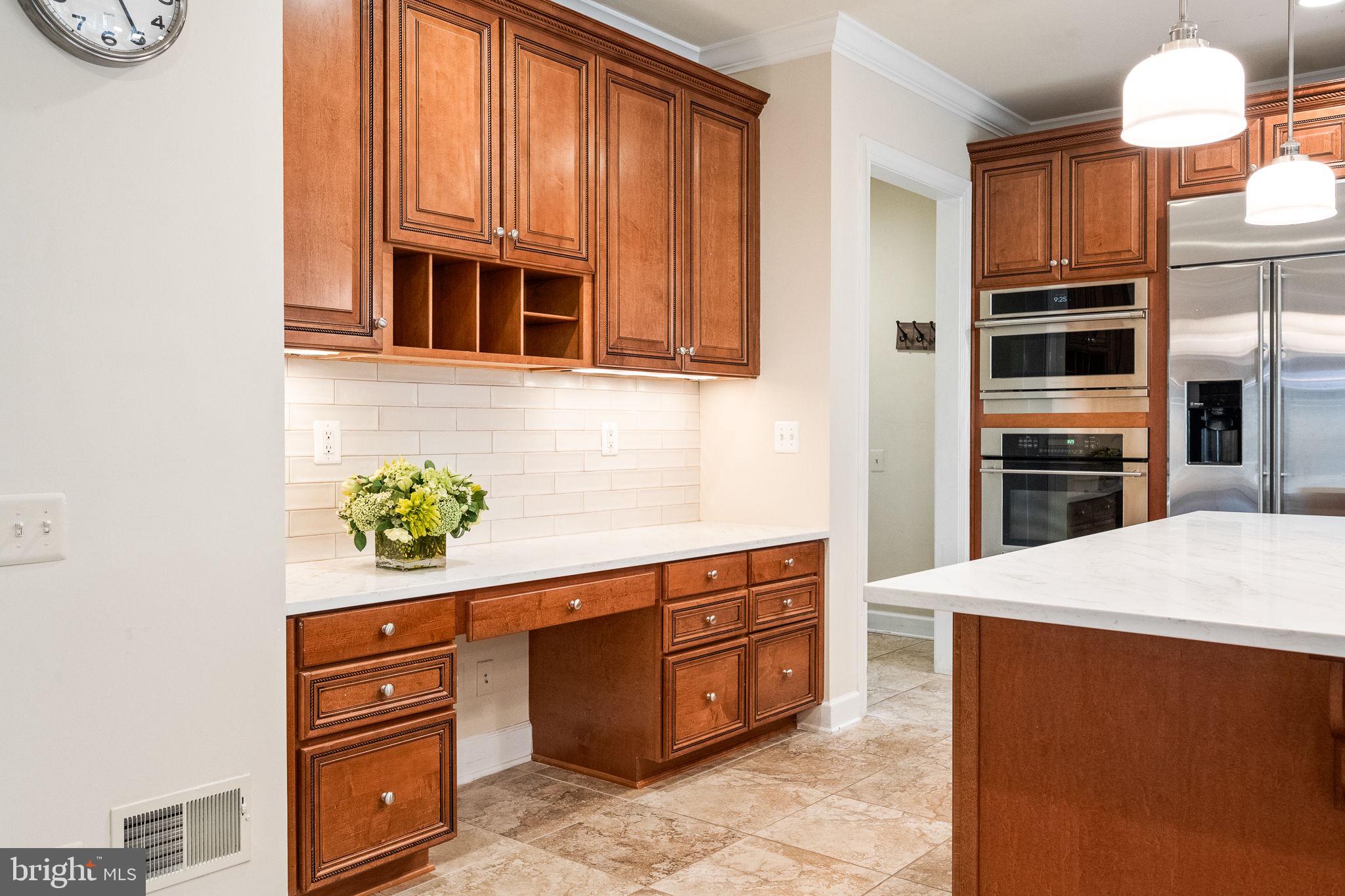 20899 McIntosh Place Leesburg, VA 20175 - Photo 12 of 69 a kitchen with stainless steel appliances granite countertop a stove and a refrigerator