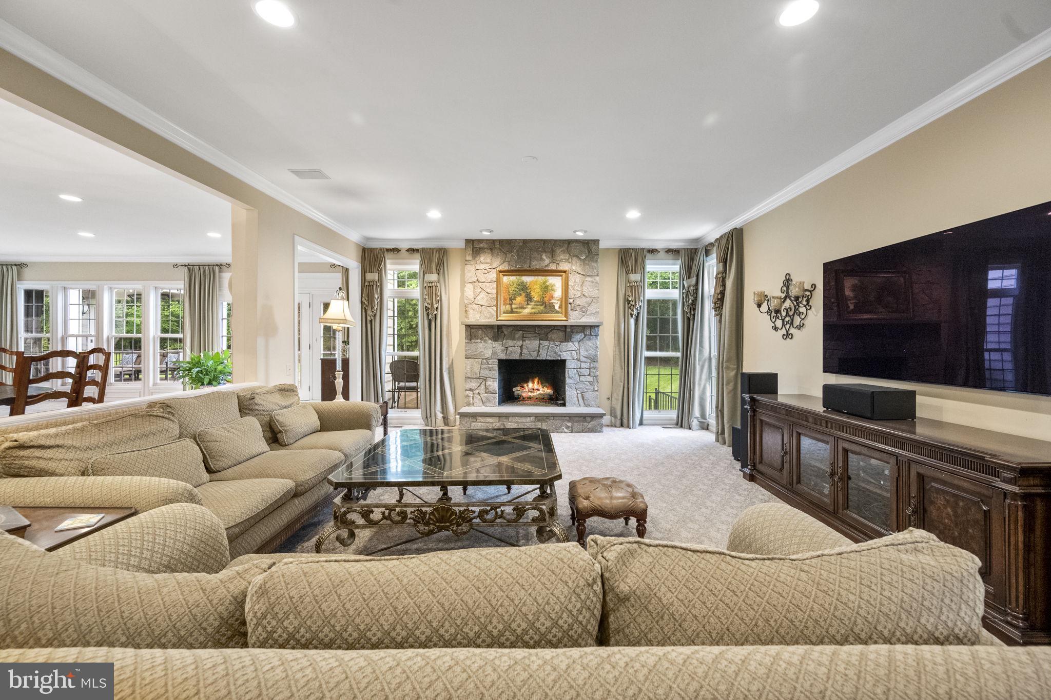 20899 McIntosh Place Leesburg, VA 20175 - Photo 23 of 69 a living room with furniture and a flat screen tv