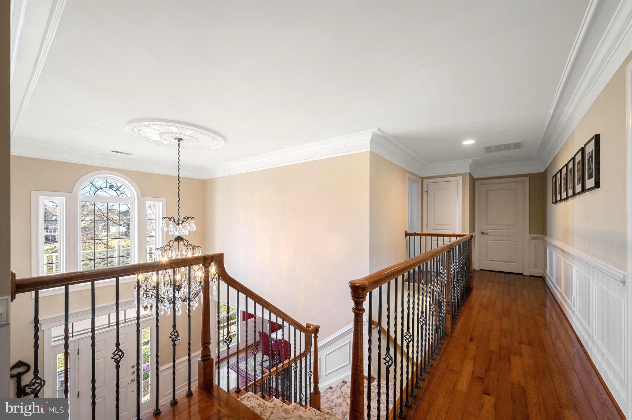20899 McIntosh Place Leesburg, VA 20175 - Photo 25 of 69 a view of a hallway with wooden floor and staircase