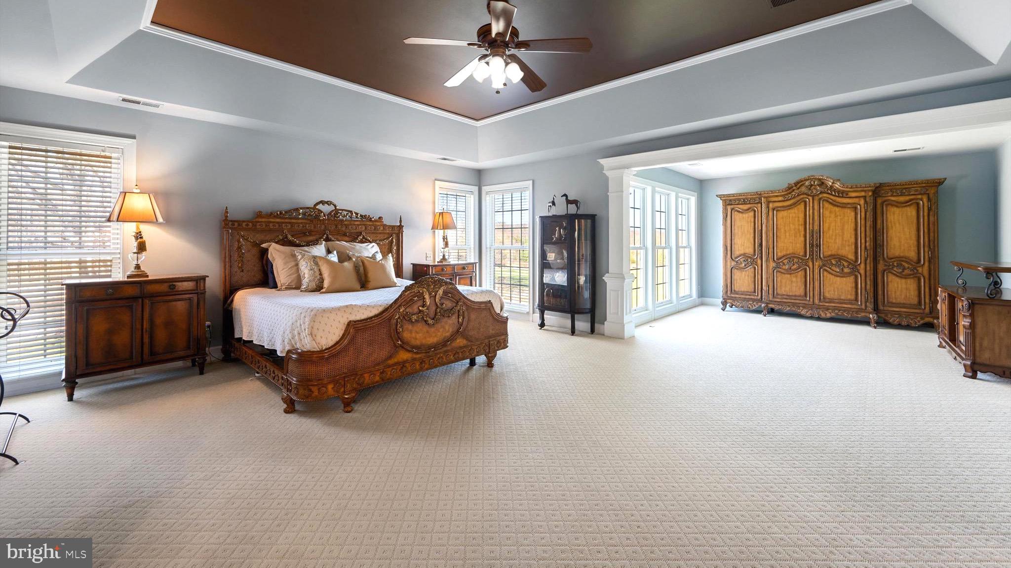 20899 McIntosh Place Leesburg, VA 20175 - Photo 26 of 69 a spacious bedroom with a bed couch and a dresser