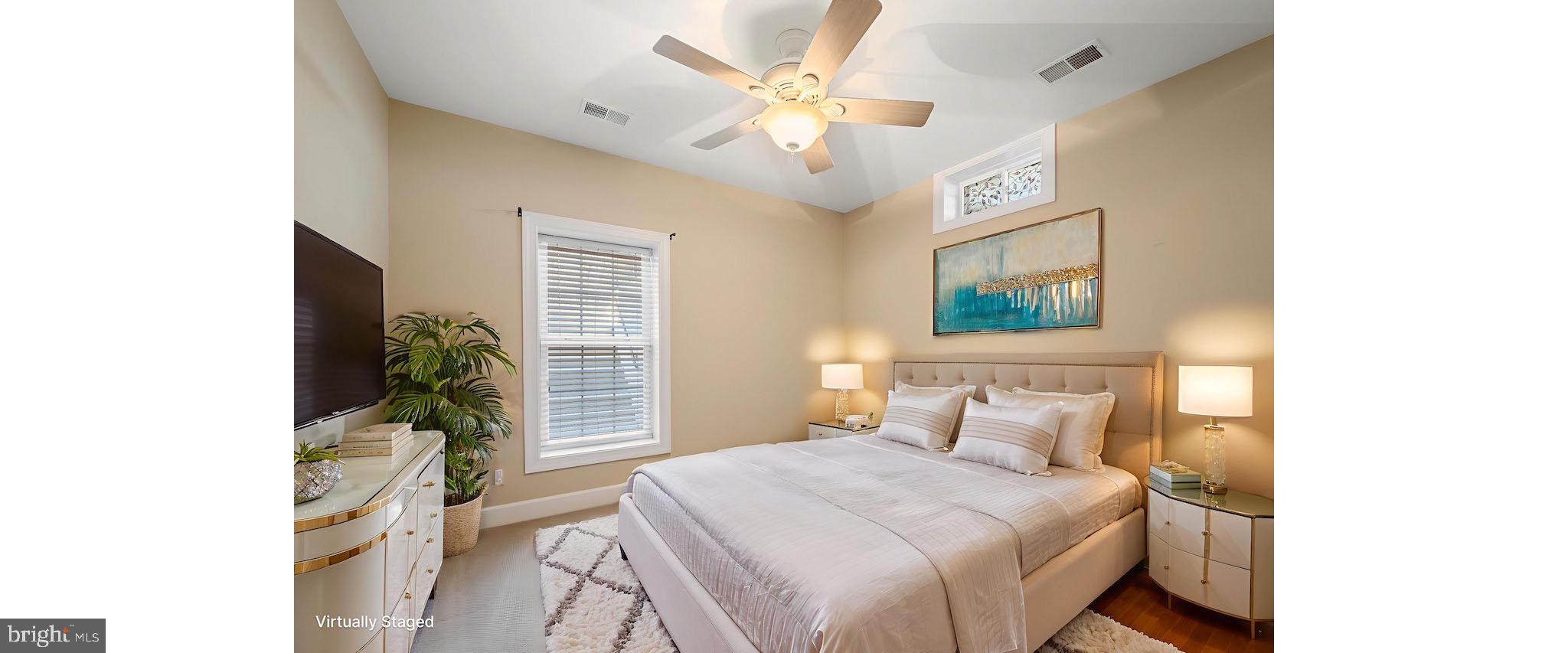 20899 McIntosh Place Leesburg, VA 20175 - Photo 37 of 69 a bedroom with a large bed and a chandelier