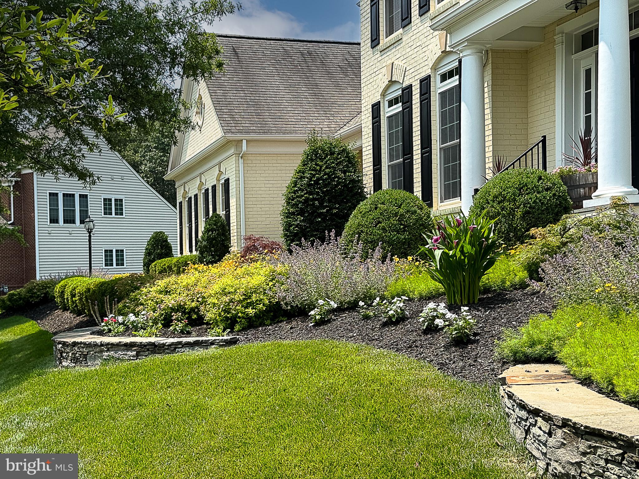 20899 McIntosh Place Leesburg, VA 20175 - Photo 42 of 69 a front view of a house with a yard