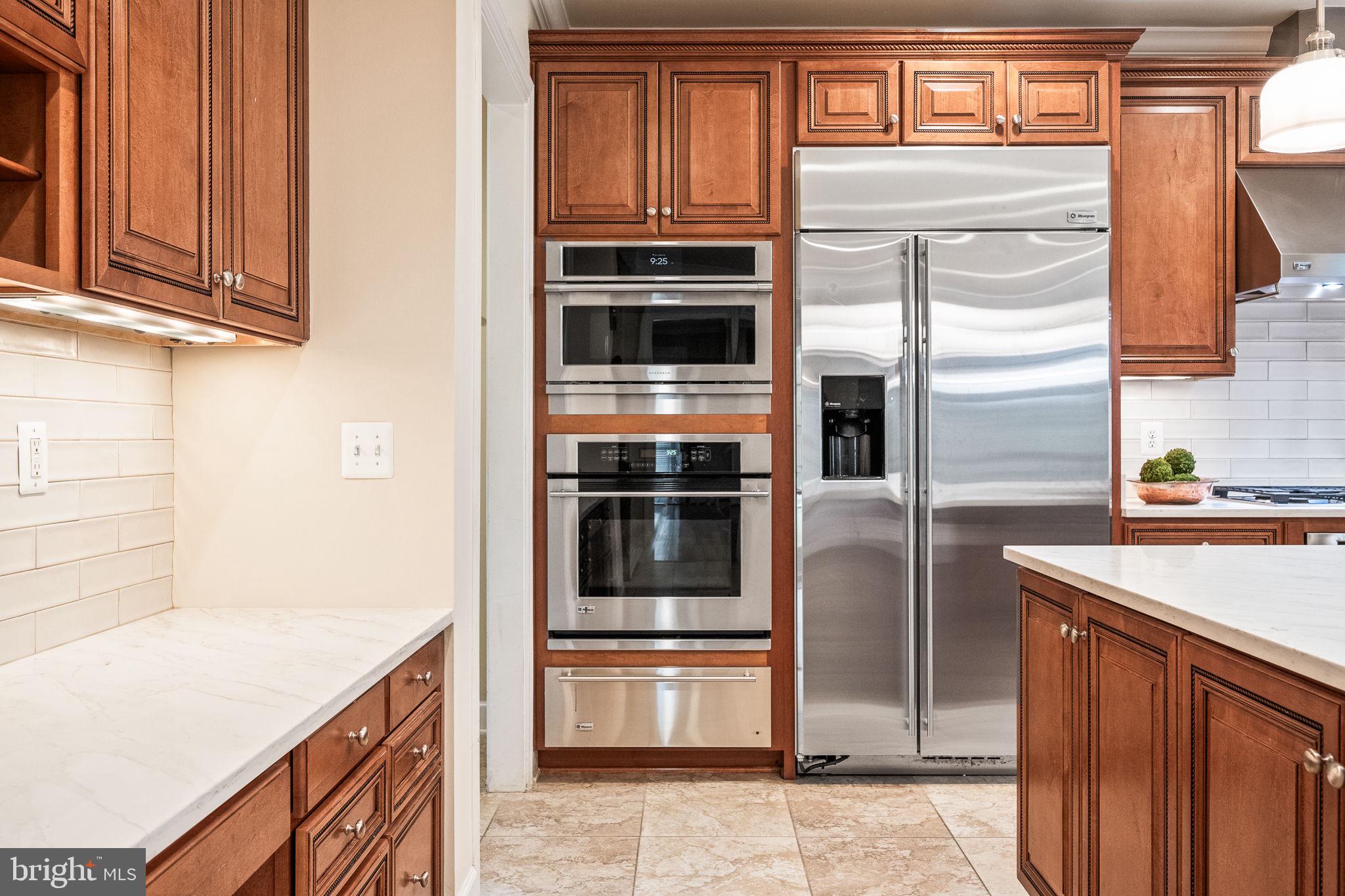 20899 McIntosh Place Leesburg, VA 20175 - Photo 6 of 69 a kitchen with stainless steel appliances granite countertop a refrigerator and a stove