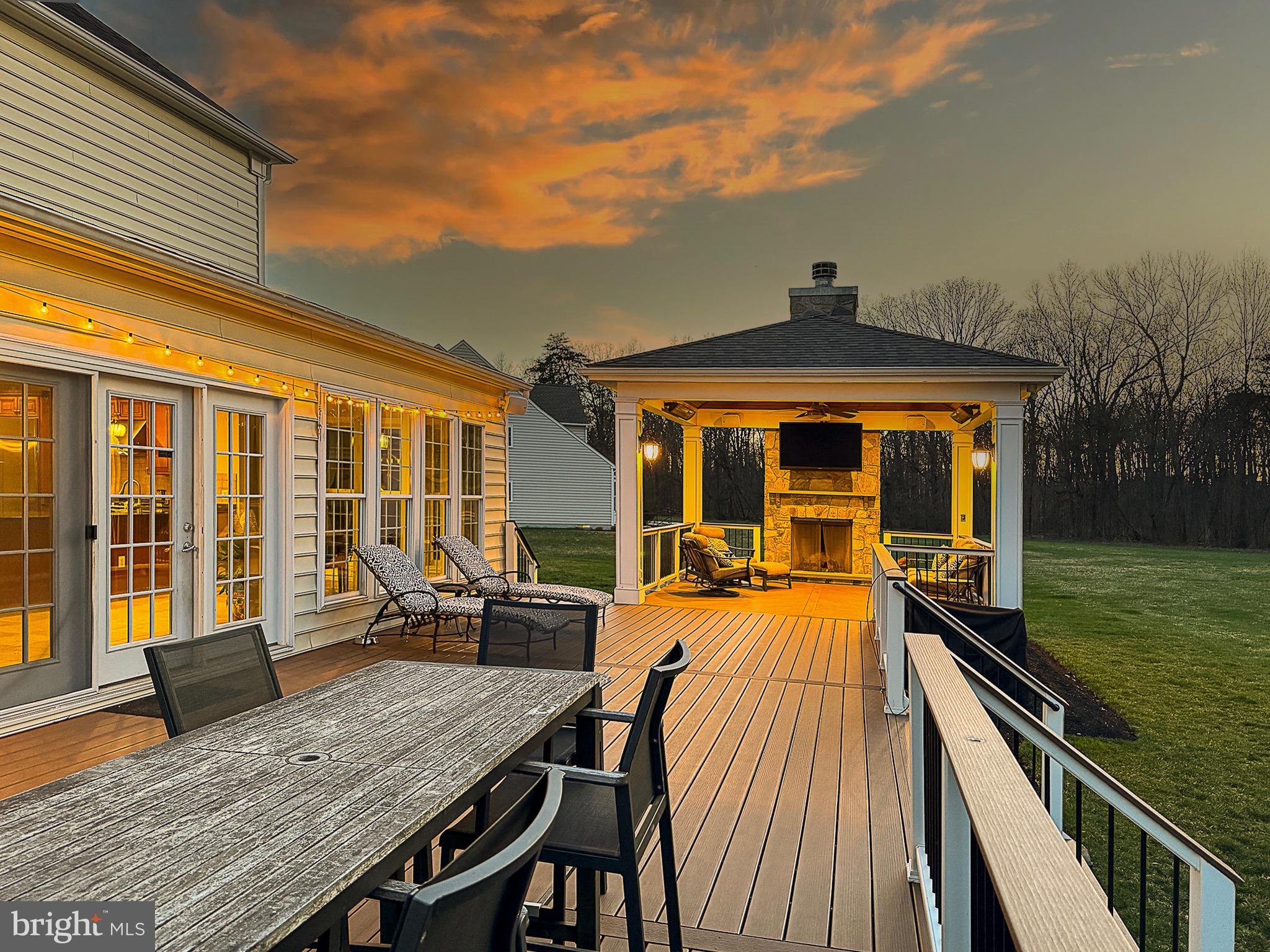 20899 McIntosh Place Leesburg, VA 20175 - Photo 67 of 69 a view of a patio with table and chairs with wooden floor and fence