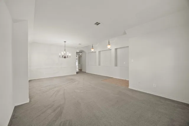 a view of a big room with white walls and refrigerator