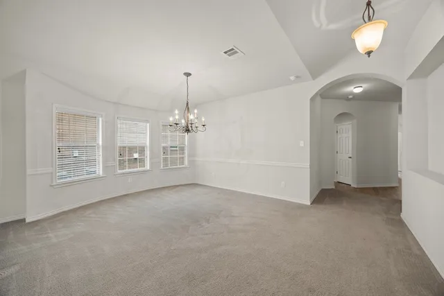 an empty room with windows and entrance