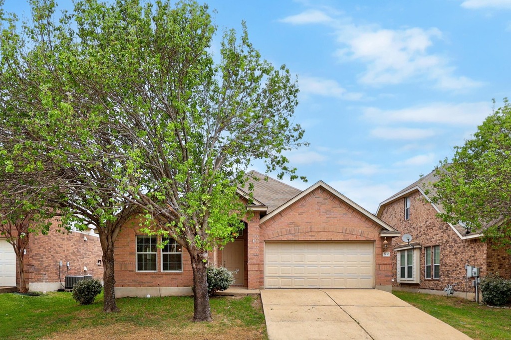 2832 Mission Tejas Drive Pflugerville, TX 78660 - Photo 2 of 30 a front view of a house with garden