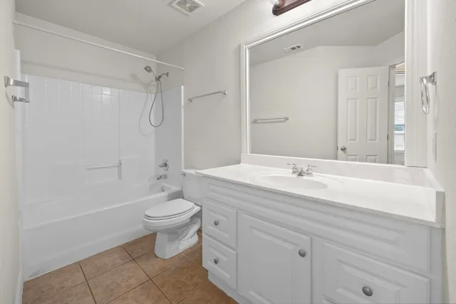 a bathroom with a double vanity sink toilet and shower